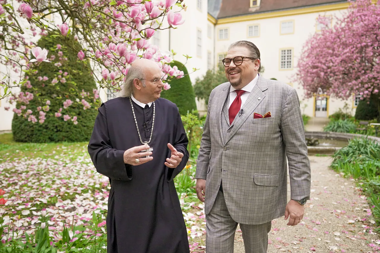 Abbot Georg Wilfinger and Michael Schade in the abbey garden in blossom