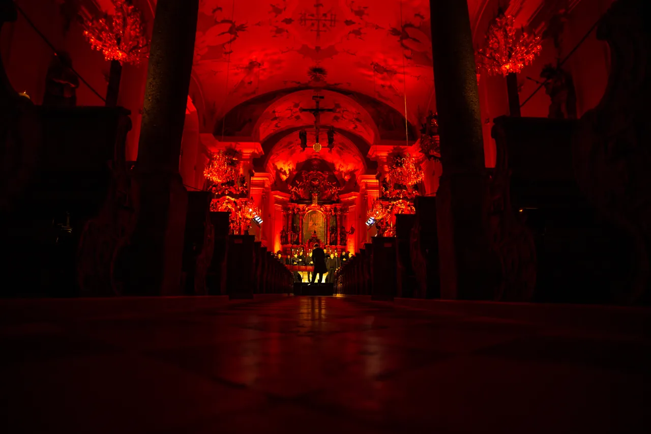 The parish church of Mittersill in red light, looking towards the high altar